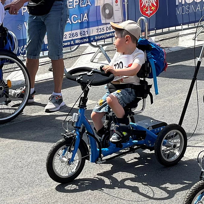 Young boy with his momo dreirad on tour