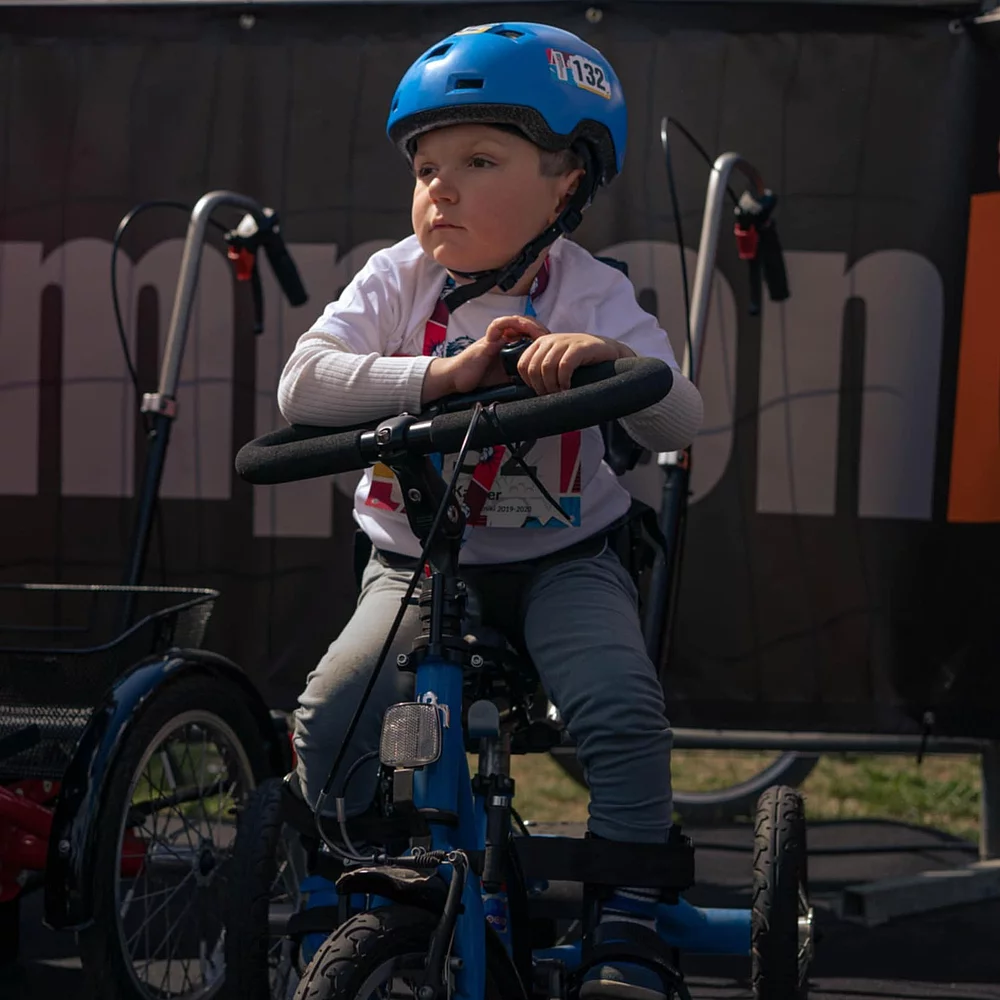 Young Boy on his momo dreirad with helmet